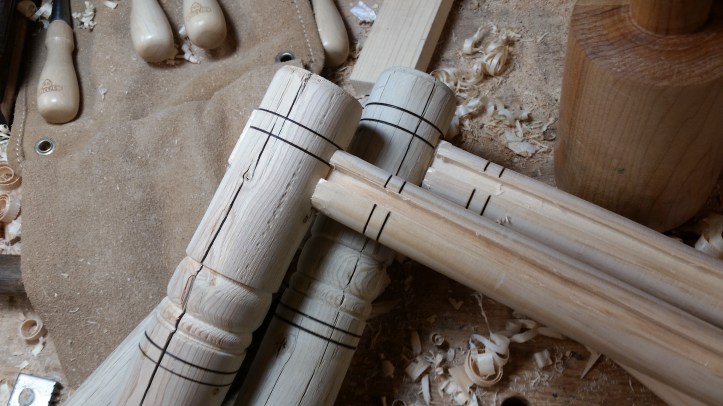 Two legs with rail tenons inserted.