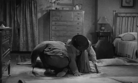 Animated GIF: The Marx Brothers saw a hole in the floor that they're kneeling on and fall through.